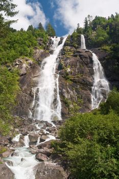 beautiful alpine waterfall in Val di Genova, Trentino, Italy