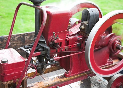 An old static steam engine in operation.