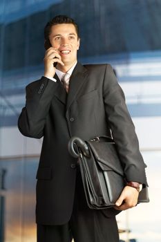 Businessman walking outside a modern building