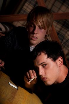 Two young men with heroin or cocaine on table