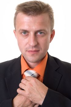 young businessman with beard adjusting his tie