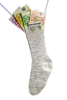 Socks with euro banknotes isolated on white background