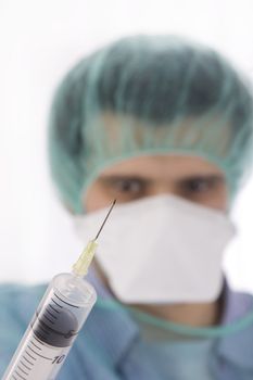 doctor holding syringe on white background
