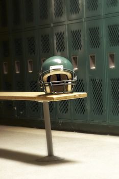 a football helmet on bench in locker room