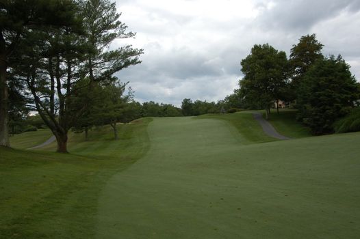 A golf fairway along a rolling course