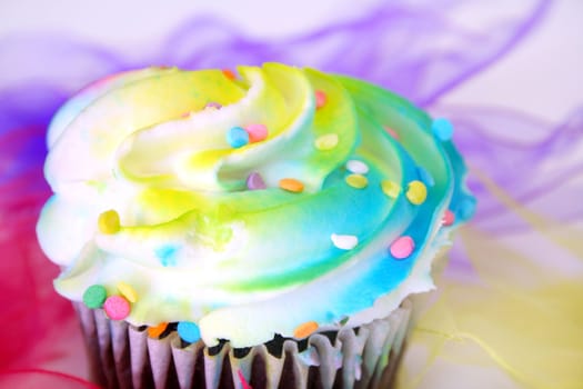 Colorful cupcake with shallow depth of field with color ribbons.