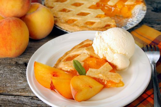 A serving of peach pie with ice cream.