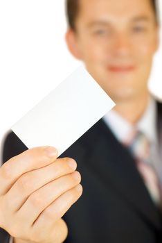 Young businessman holding blank visit card. Backside. Isolated.