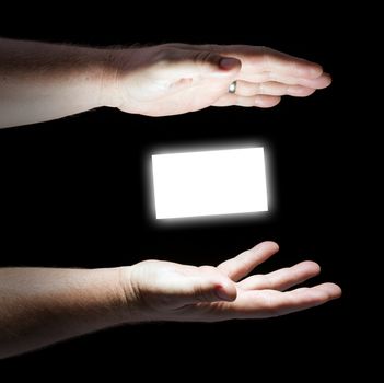 Floating Business Card Between Hands on a Black Background.