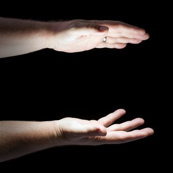 Glowing Hands on Black Background Ready for Your Product.