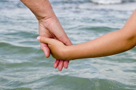 Two people hold hands and 
  go to sea