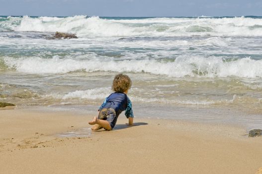 Beby on the sand at the sea