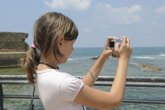 The girl stands on the shore of the sea and landscape photographs