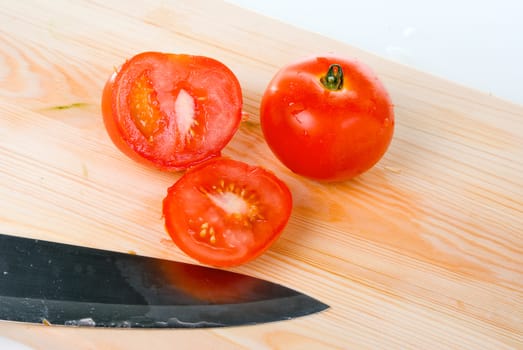 tomatoes and knife on wood table