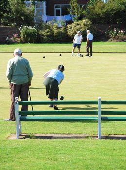 Group of seniors enjoying game of bowls