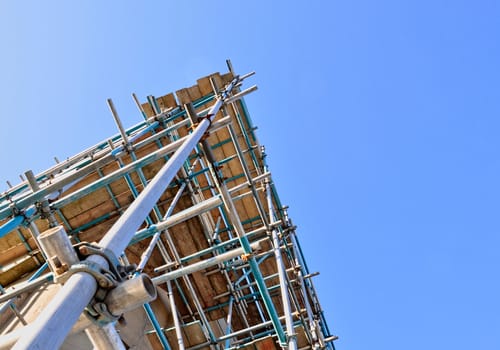 View of scaffolding tower against cloudless blue sky