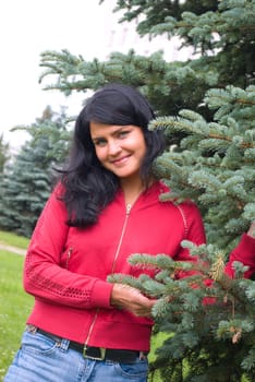 The young girl near to a fur-tree