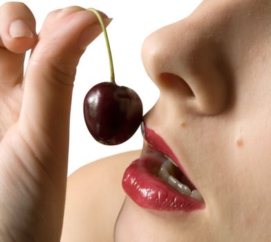 young girl to eat cherry. Isolated