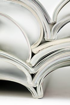 stack of colorful magazines on white background