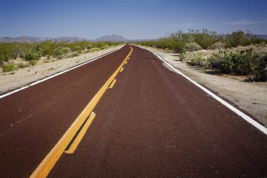 Red asphalt road in California, United States.