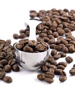 spoon full of coffee beans isolated on white background