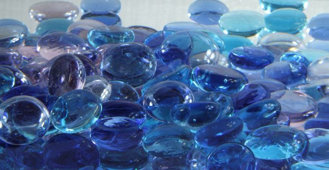 A pile of blue glass stones piled together.