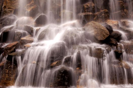 Details of beautiful waterfall crashing on rocks.