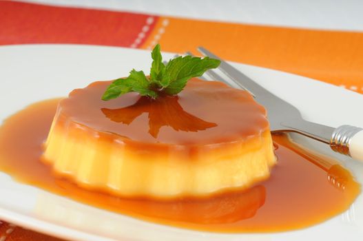 Delicious creme caramel with a sprig of mint.