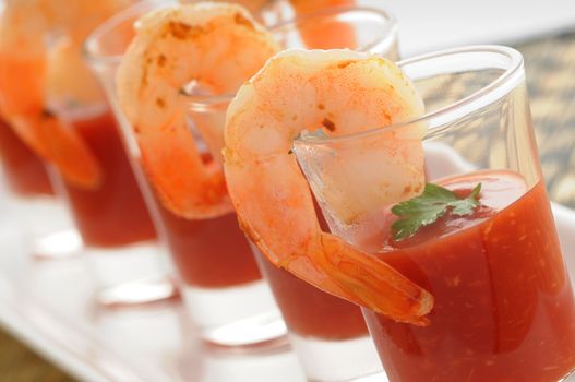 Shrimp cocktail in shot glass shot closeup.