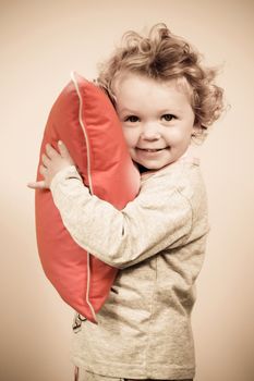 cute girl hugging pink pillow