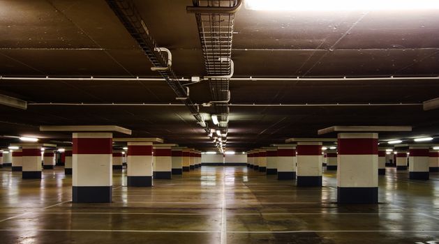 Empty underground parking, reflections on the floor