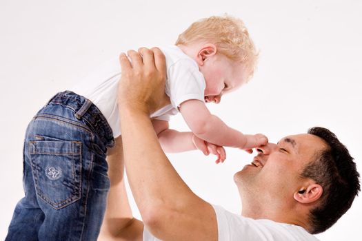 Cute caucasian toddler haves fun with his daddy