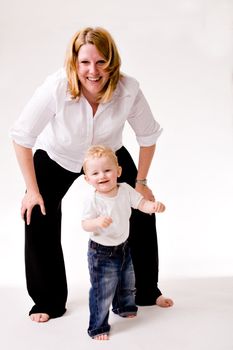 Cute caucasian blond toddler is happy with his mother