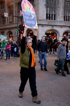 CHICAGO, IL-MAR. 18, 2010: Protesters march through downtown Chicago, demonstrating against US military involvement in Iraq and Afghanistan on March 18, 2010.