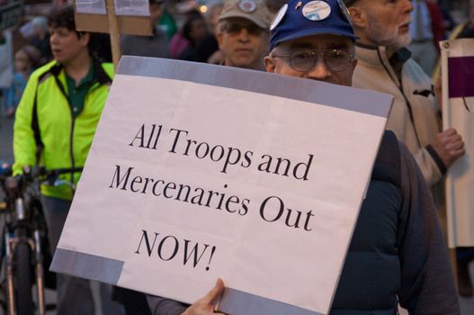 CHICAGO, IL-MAR. 18, 2010: Protesters march through downtown Chicago, demonstrating against US military involvement in Iraq and Afghanistan on March 18, 2010.