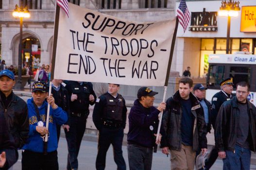 CHICAGO, IL-MAR. 18, 2010: Protesters march through downtown Chicago, demonstrating against US military involvement in Iraq and Afghanistan on March 18, 2010.