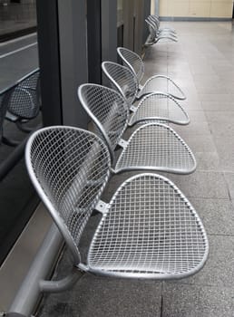 raw of metal chairs in a railway station 