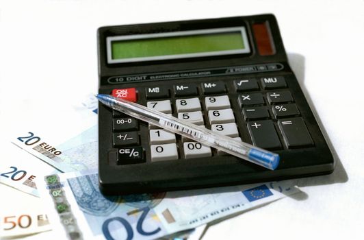 Calculator, pen and banknotes on white