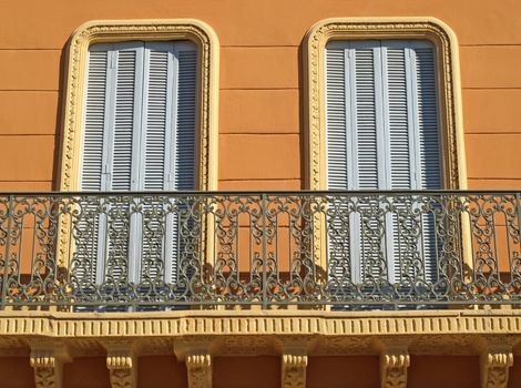 windows on a balconiy of an ancient building