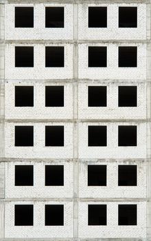 Under construction building. Industrial background. Black windows rows.