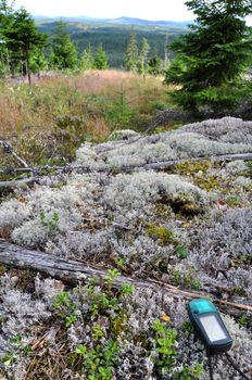 A view from the swedish wilderness with a GPS-unit in the foreground