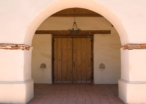 The arch and doorway of a very old Spanish mission