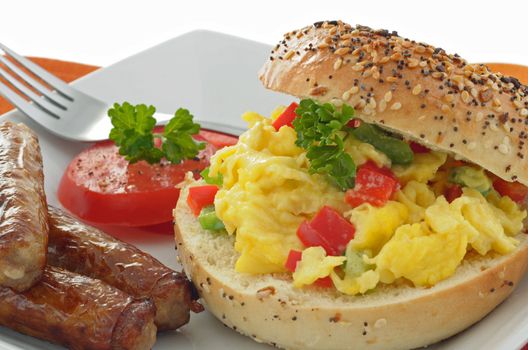 Delicious breakfast bagel with egg and sausage.