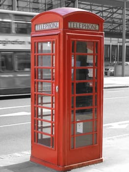 Traditional red telephone box in London, UK - selective black & white background