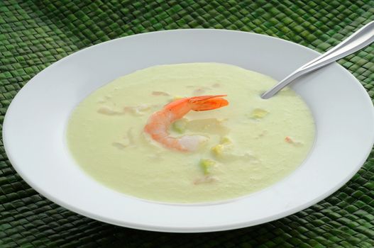 Refreshing cold avocado, cucumber and shrimp soup.