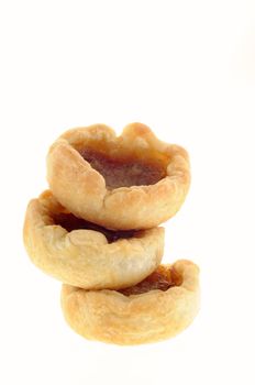 Delicious fresh homemade butter tarts isolated on white.