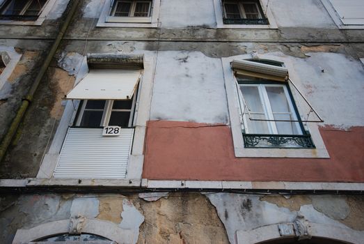 detail of an old building with damaged blinds in Lisbon