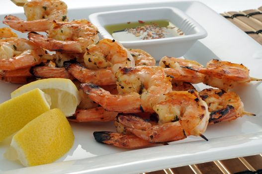Delicious grilled shrimp with lemon and dipping sauce.
