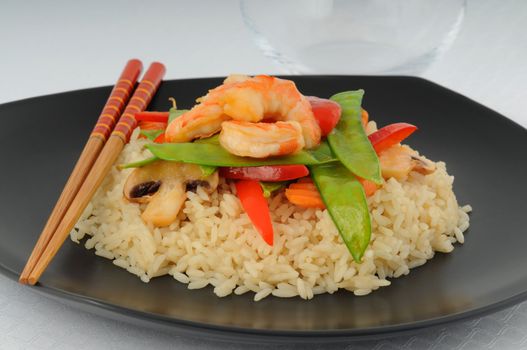 Delicious shrimp and vegetables on white rice.