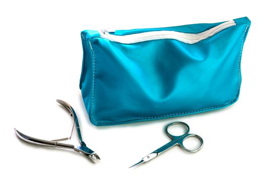 Blue beautician and nail scissors - manicure set on isolated background.